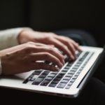 A person is typing on his computer.